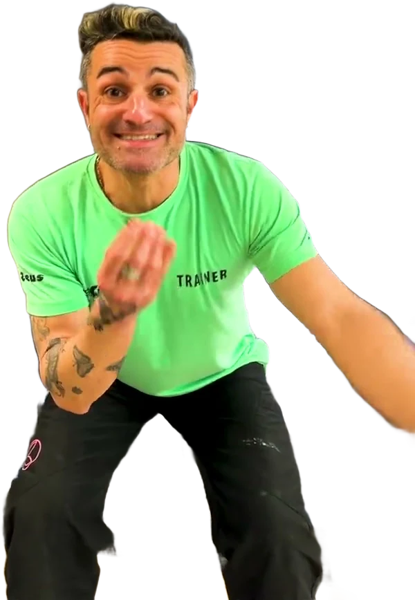 Un trainer di Nuovo Mondo Fitness, in maglia verde, seduto sulle scale della palestra